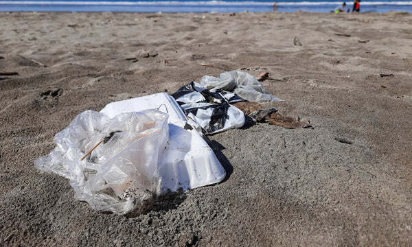 Image of a Polluted beach with Styrofoam and plastic waste.